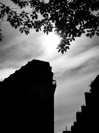 Low angle view of silhouette buildings against sky at sunset
