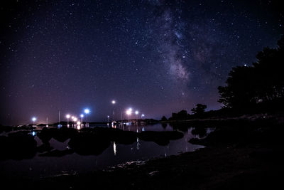 Scenic view of illuminated trees against sky at night