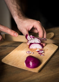 Close-up of person preparing food on cutting board