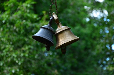 Low angle view of bell hanging on tree