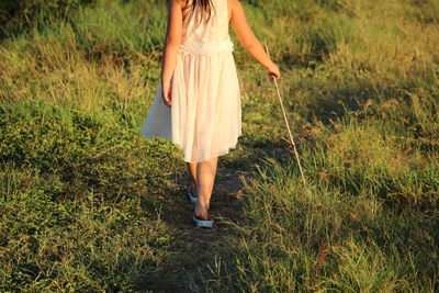 Low section of girl walking on land