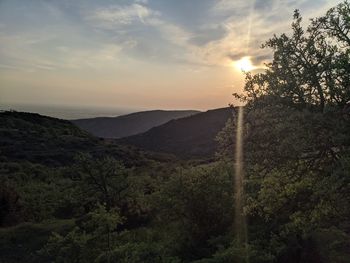 Scenic view of mountains against sky at sunset