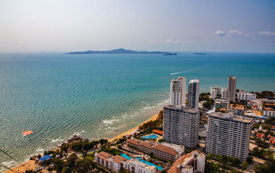 High angle view of buildings by sea against sky