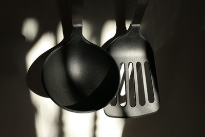 Close-up of kitchen utensil hanging on wall