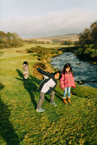 Full length of kids playing on field