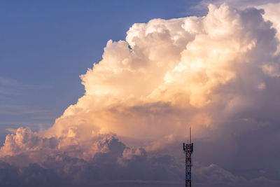 Low angle view of communications tower against sky during sunset