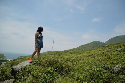 Full length of woman standing on grass