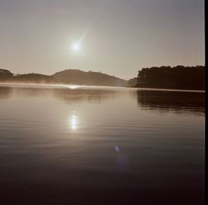 Scenic view of lake against sky during sunset