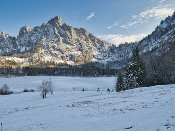 Scenic view of snow covered mountains against sky