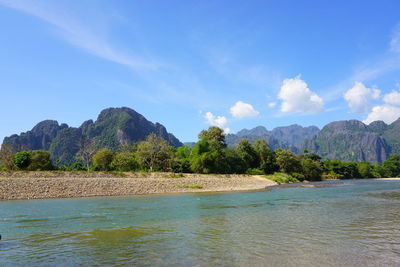 Scenic view of sea and mountains against sky