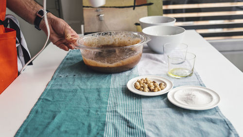 High angle view of man preparing food on table