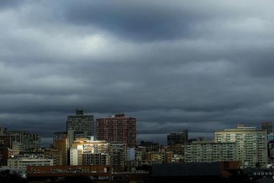 High angle view of buildings against cloudy sky