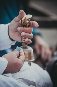 Midsection of man cleaning bell