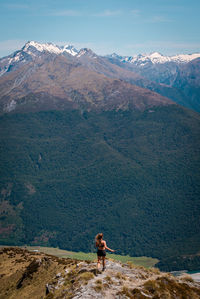 Rear view of woman standing on mountain