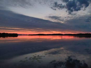 Scenic view of sea against dramatic sky during sunset