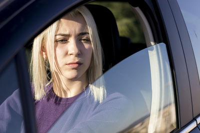 Portrait of young woman in car
