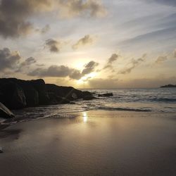 Scenic view of beach against sky during sunset