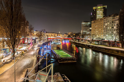 Canal passing through city at night