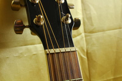 Cropped image of guitar on fabric