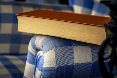 Close-up of book on armchair