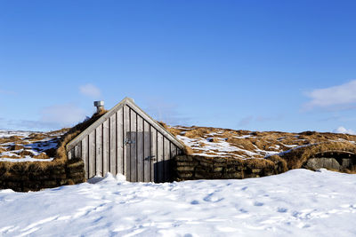 Tiny hut with blue sky in snowy iceland