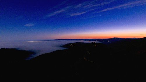 Scenic view of silhouette landscape against sky at night