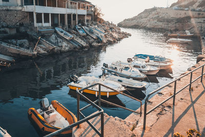 High angle view of boats moored at harbor by buildings