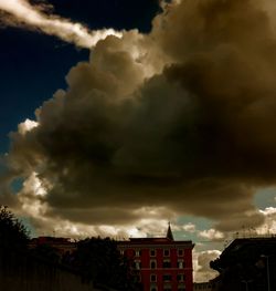 Low angle view of building against cloudy sky