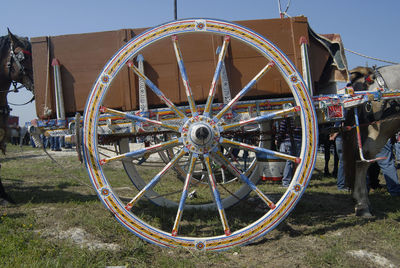 Ferris wheel on field against sky