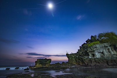 Scenic view of sea against sky at night