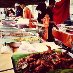 People for sale at market stall