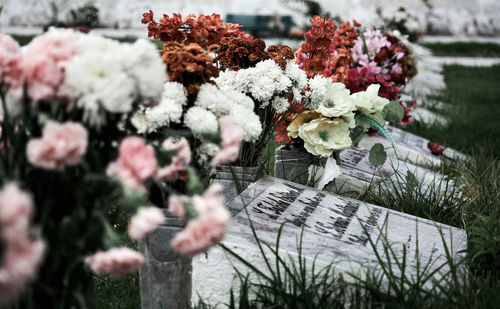 Flowers on a gravestone marker at a cemetery grave