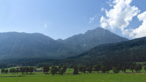 Scenic view of landscape and mountains against sky