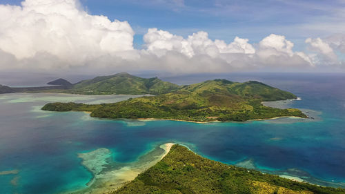 Scenic view of sea and mountains against sky