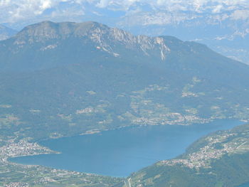 Aerial view of city by sea against sky