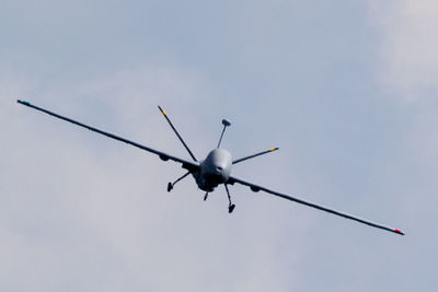 Low angle view of airplane flying against sky