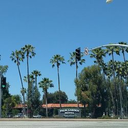 Low angle view of road sign against clear blue sky