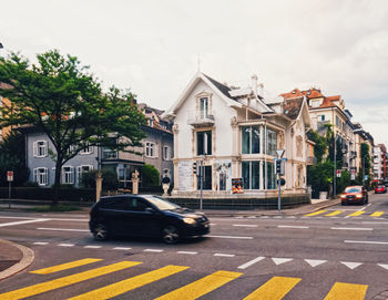 Cars on street against sky