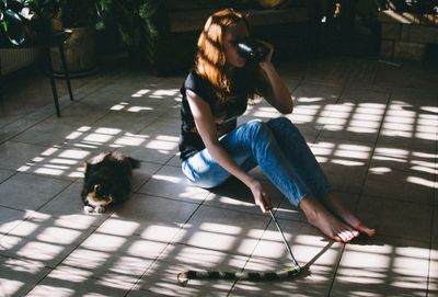 Full length of woman sitting on bench