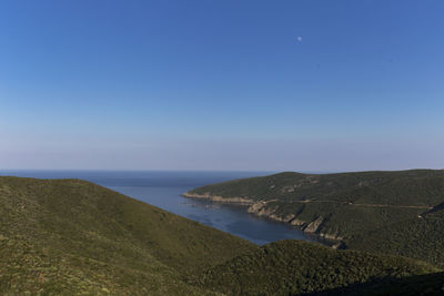 Scenic view of sea against clear blue sky