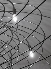 Low angle view of illuminated light bulb against sky