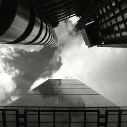 Low angle view of modern building against cloudy sky