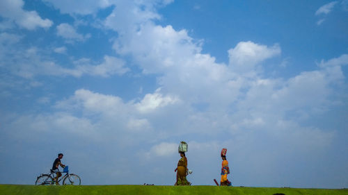 People on field against sky