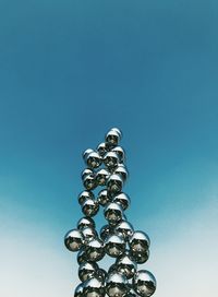 Low angle view of metallic structure against blue sky