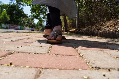 Low section of man walking on street