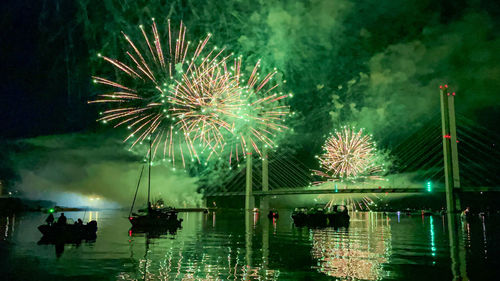 High angle view of firework display at night