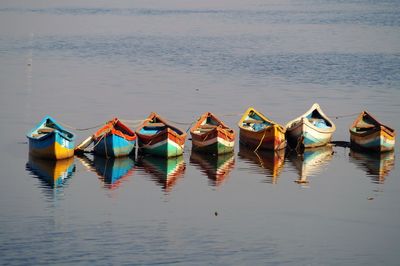 Boats moored in lake against sky