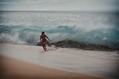 Full length of man on beach against sky