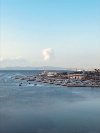 Bridge over sea against sky in city