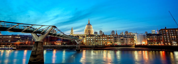 Illuminated buildings in city at dusk